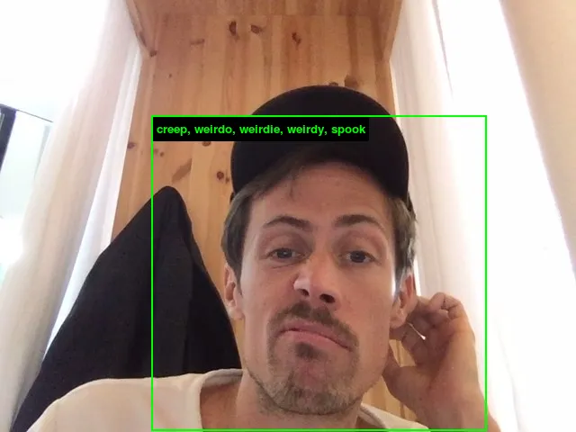 Selfie in a black cap, framed by a green face-detection box labelled “creep, weirdo, weirdie, weirdy, spook”