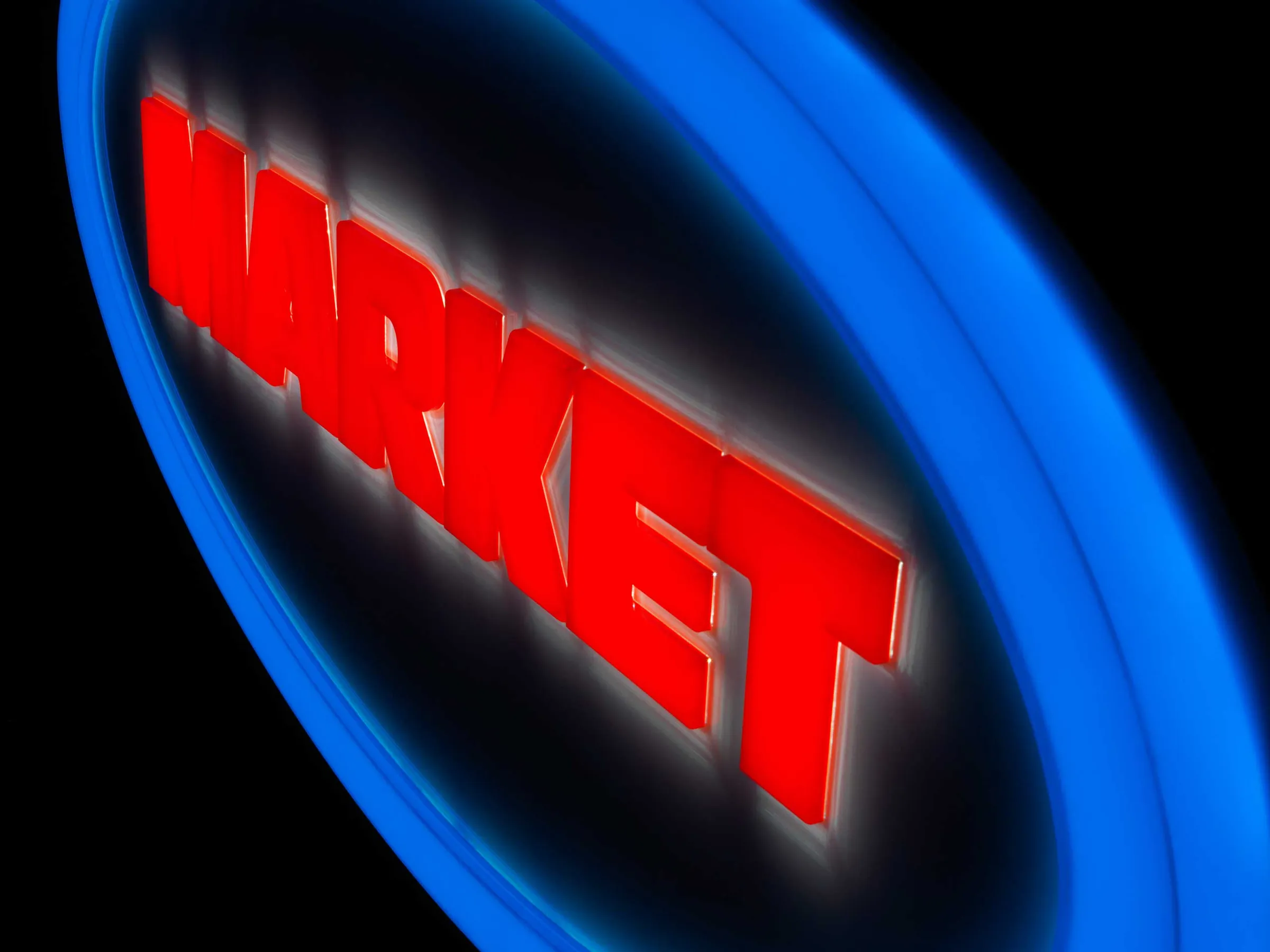 Market sign at night: red “MARKET” glowing inside a blue ring