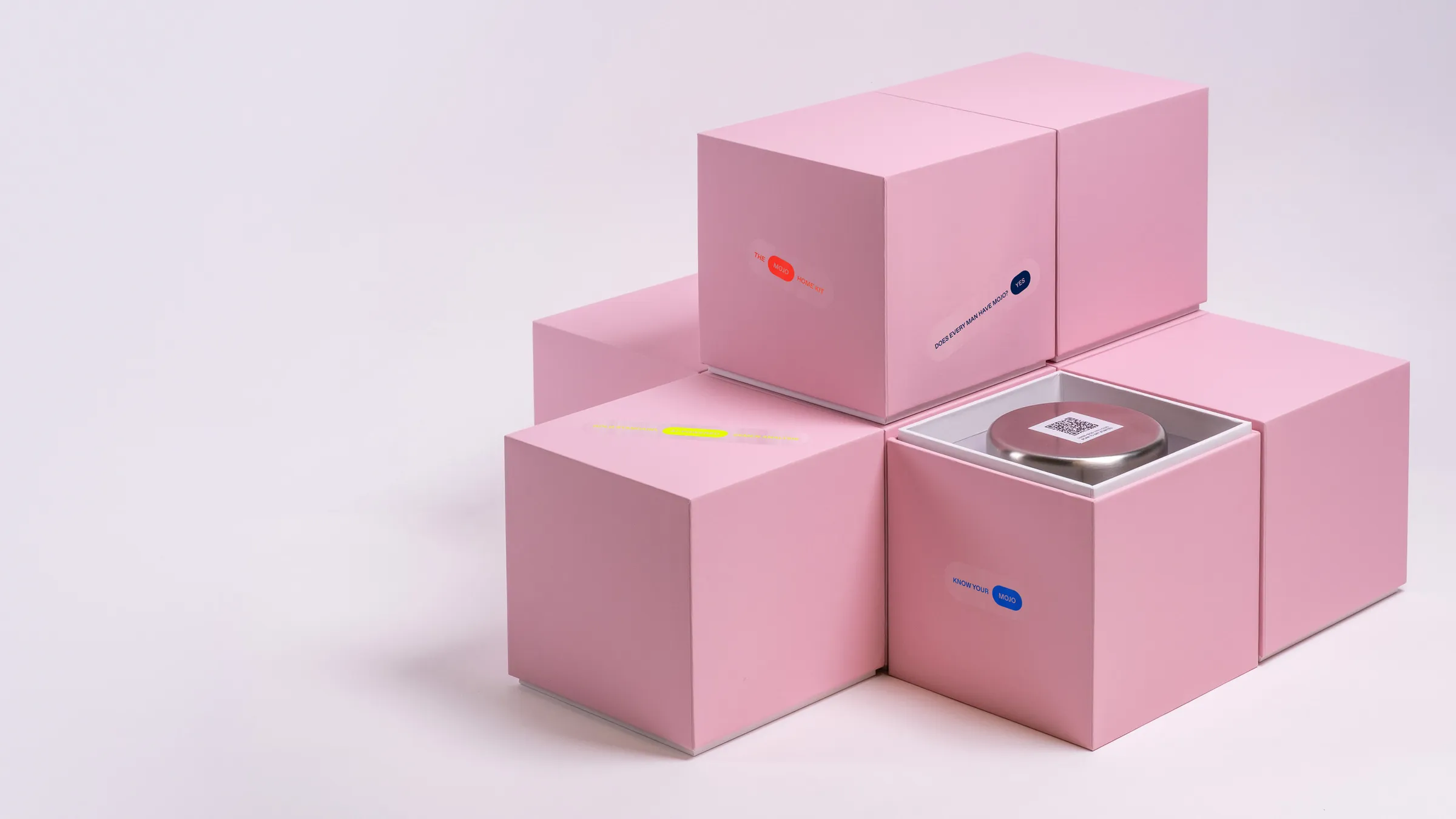 Mojo home kit: stacked pink boxes, one open to reveal a silver temperature-controlled container with a QR code