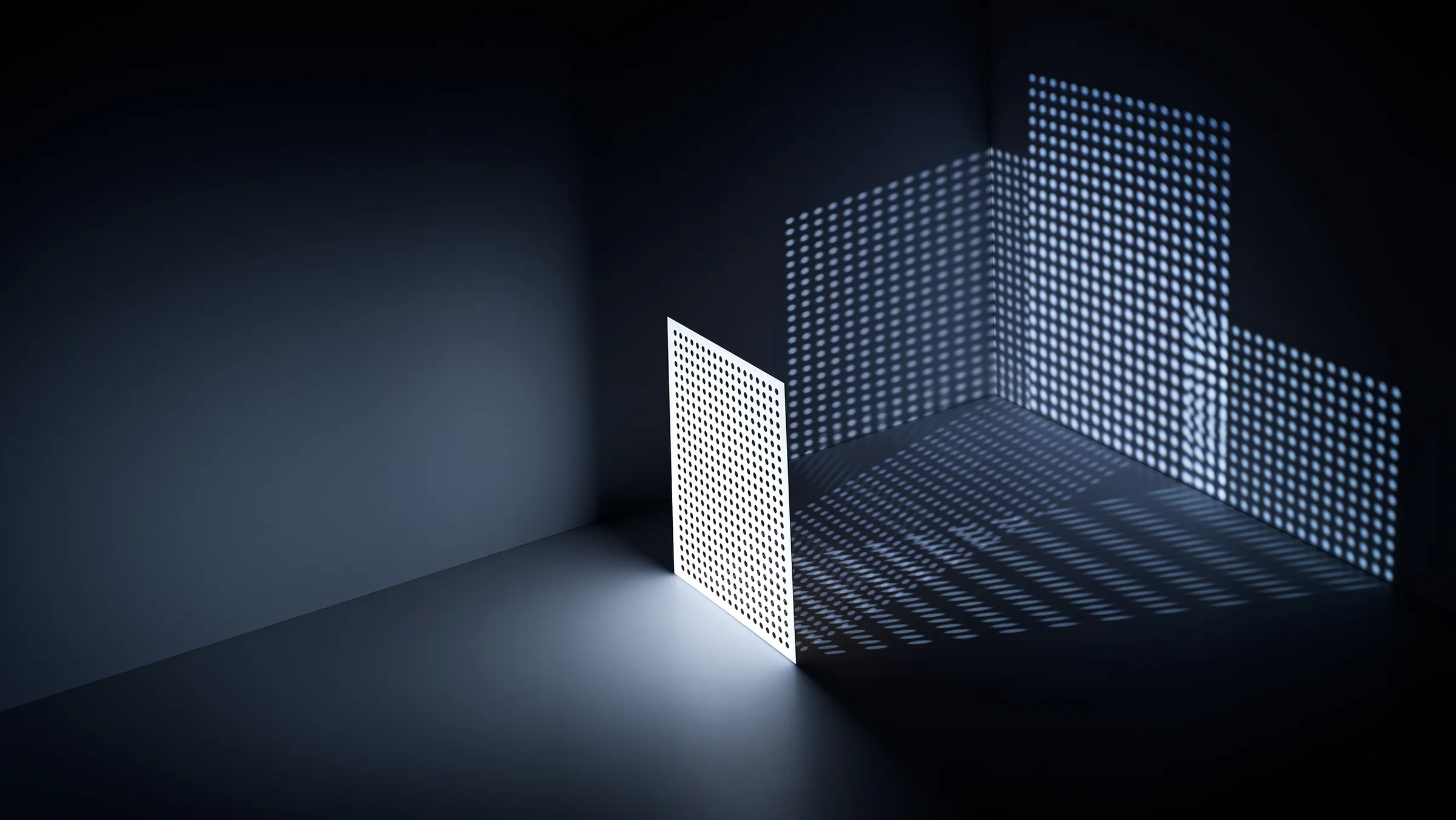 White panel with a fine grid of square holes, casting a dotted light pattern into a dark corner