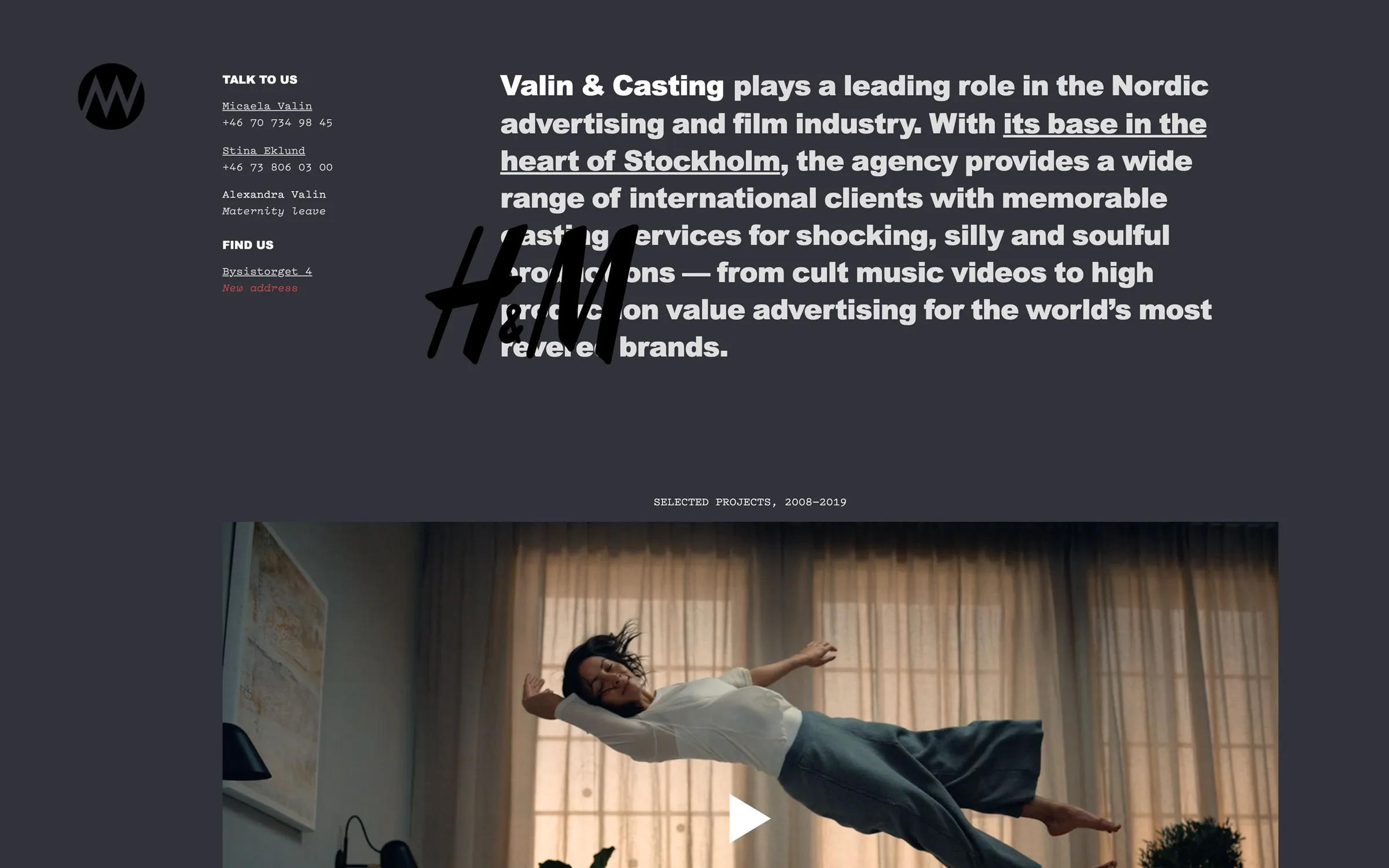 Dark web page with large intro text, an H&M logo on hover, and a video still of a woman floating mid-air